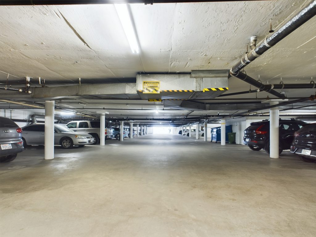 An apartment complex in Sherman Oaks with a parking garage filled with cars.